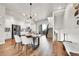 Open living space featuring a dining area, a staircase, and a modern kitchen with stainless steel appliances at 1575 W 68Th Ave, Denver, CO 80221