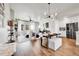 Bright, open concept living area with hardwood floors, modern lighting, and stylish furniture throughout at 1575 W 68Th Ave, Denver, CO 80221