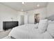 Comfortable main bedroom featuring neutral tones, a dresser, and a walk-in closet at 1575 W 68Th Ave, Denver, CO 80221