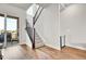 Bright staircase with hardwood floors and a modern railing at 1575 W 68Th Ave, Denver, CO 80221
