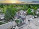Aerial view captures the residential neighborhood, showcasing home exteriors, landscaping, and mountain views at sunset at 1866 S Pennsylvania St, Denver, CO 80210