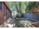 Enclosed backyard with mature trees provides a shady retreat, enhancing the home's outdoor living space at 1866 S Pennsylvania St, Denver, CO 80210