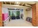 Finished basement playroom features a bright mural, fun decor, and red brick accents at 1866 S Pennsylvania St, Denver, CO 80210