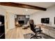 Finished basement living room features a decorative beam, light flooring, and modern furniture at 1866 S Pennsylvania St, Denver, CO 80210