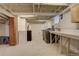 Unfinished basement laundry area features exposed ceilings and a modern washer and dryer at 1866 S Pennsylvania St, Denver, CO 80210