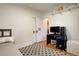 Simple bedroom with hardwood floors, a desk area, and a closet, providing a functional living space at 1866 S Pennsylvania St, Denver, CO 80210