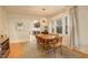 Elegant dining area with hardwood floors, a modern chandelier, and a view into the kitchen at 1866 S Pennsylvania St, Denver, CO 80210