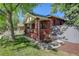 Classic brick home featuring lush greenery and a side entrance for added convenience at 1866 S Pennsylvania St, Denver, CO 80210