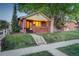 Charming brick home featuring a cozy front porch and manicured lawn, perfect for relaxation at 1866 S Pennsylvania St, Denver, CO 80210