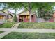 Charming brick home featuring a cozy front porch and manicured lawn, perfect for relaxation at 1866 S Pennsylvania St, Denver, CO 80210