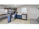 Kitchen features stainless steel appliances, blue cabinets, and open shelving at 1866 S Pennsylvania St, Denver, CO 80210