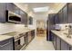 Stylish kitchen with stainless steel appliances, granite countertops, sleek dark cabinets, and plenty of counter space at 1866 S Pennsylvania St, Denver, CO 80210