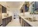 Modern kitchen featuring dark cabinets, stainless steel appliances, granite countertops, and ample counter space at 1866 S Pennsylvania St, Denver, CO 80210