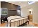 Comfortable bedroom with a dark accent wall, hardwood floors, and a bathroom, offering a relaxing retreat at 1866 S Pennsylvania St, Denver, CO 80210