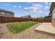 Well-maintained backyard with a neatly trimmed lawn, gravel landscaping, and a concrete patio at 25466 E 4Th Pl, Aurora, CO 80018