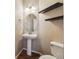 Modern half bathroom with floating shelves and pedestal sink at 25466 E 4Th Pl, Aurora, CO 80018