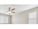 A modern ceiling fan with five blades and a light fixture centered in a room with two windows at 25466 E 4Th Pl, Aurora, CO 80018