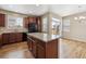 Kitchen island with wood cabinets, stainless steel appliances, and wooden floors at 25466 E 4Th Pl, Aurora, CO 80018
