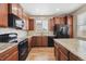Kitchen with granite counters, stainless steel appliances, and wooden floors at 25466 E 4Th Pl, Aurora, CO 80018