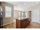 Kitchen island with wood cabinets and granite countertop at 25466 E 4Th Pl, Aurora, CO 80018
