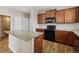 Kitchen island featuring granite counters and wood cabinets at 25466 E 4Th Pl, Aurora, CO 80018