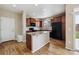 Well-lit kitchen with granite counters, an island, and stainless steel appliances at 25466 E 4Th Pl, Aurora, CO 80018