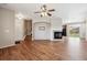 Bright living room featuring hardwood floors, fireplace, ceiling fan and access to backyard through sliding glass doors at 25466 E 4Th Pl, Aurora, CO 80018