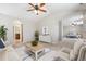 Open-concept living room with neutral decor and hardwood floors at 25466 E 4Th Pl, Aurora, CO 80018