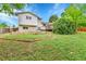 Large grassy backyard with a wooden deck and tiered garden beds perfect for outdoor enjoyment at 13134 Deneb Dr, Lone Tree, CO 80124