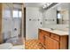Bathroom with a sliding glass shower door, tile walls, vanity, sink, and mirrored cabinet at 13134 Deneb Dr, Lone Tree, CO 80124