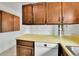 Kitchen features wood cabinets, yellow countertops, and Bosch dishwasher at 13134 Deneb Dr, Lone Tree, CO 80124