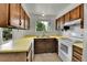 Traditional kitchen features wood cabinets, yellow counters and white appliances at 13134 Deneb Dr, Lone Tree, CO 80124
