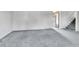 Bright living room with gray carpet leading to stairway and open doorway to the kitchen at 13134 Deneb Dr, Lone Tree, CO 80124