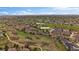 Beautiful community aerial view with pond, mature trees and lush green spaces at 7750 S Buchanan Way, Aurora, CO 80016