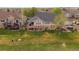 Expansive backyard featuring a large deck, green lawn, and mature trees in a residential neighborhood at 7750 S Buchanan Way, Aurora, CO 80016