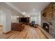Finished basement with a stone fireplace and wood flooring at 7750 S Buchanan Way, Aurora, CO 80016