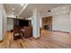 Finished basement with a stone fireplace and wood flooring at 7750 S Buchanan Way, Aurora, CO 80016