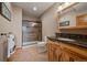 Bathroom features a glass enclosed shower, wooden vanity, and granite countertop at 7750 S Buchanan Way, Aurora, CO 80016