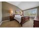 Cozy bedroom with a sleigh bed, plantation shutters, and soft, warm tones at 7750 S Buchanan Way, Aurora, CO 80016