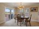 Dining room with elegant chandelier and sliding glass doors leading to an outdoor deck at 7750 S Buchanan Way, Aurora, CO 80016