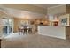 Bright and airy dining area with an adjacent kitchen and patio doors at 7750 S Buchanan Way, Aurora, CO 80016