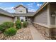 Charming single-story home with stone accents, mature landscaping, and inviting entrance at 7750 S Buchanan Way, Aurora, CO 80016