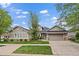 Charming single-story home with a well-manicured lawn, two-car garage, and beautiful stone accents at 7750 S Buchanan Way, Aurora, CO 80016