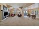Open living room with fireplace, vaulted ceilings, carpet floors and dining area at 7750 S Buchanan Way, Aurora, CO 80016