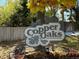 Sign for the Copper Oaks community surrounded by landscaping and mature trees at 10890 W Evans Ave # 3D, Lakewood, CO 80227