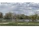 Scenic view of a lake with trees and a bench at 10890 W Evans Ave # 3D, Lakewood, CO 80227