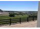 Sweeping view of the rolling hills and landscape that overlook the home and fence at 4316 Ridgewalk Pt, Arvada, CO 80007