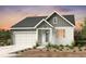 Charming single-story home featuring a two-car garage and a welcoming front porch at 4316 Ridgewalk Pt, Arvada, CO 80007