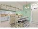 Cozy dining area with modern lighting, a table with bench seating, and easy access to the kitchen at 1404 Whitehall Dr # C, Longmont, CO 80504