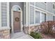 Charming condo entrance with a wreath, decorative stone accents, and a welcoming doorway at 1404 Whitehall Dr # C, Longmont, CO 80504